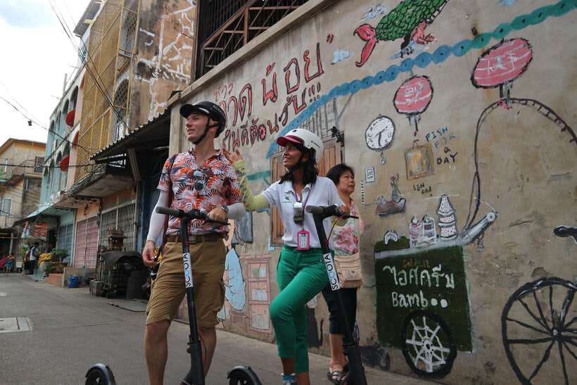 Bangkok: Riverside E-Scooter Adventure with StreetFood Snack - The ferry ride and Tha Din Daeng Market