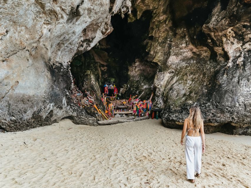 Krabi: 4 Islands Tour by Longtail Boat & Thai Buffet Lunch - Phra Nang Cave Beach: cliffs, sand, and a surprising shrine